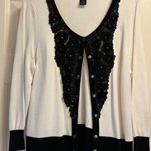 White House Black Market white sweater with black trim.